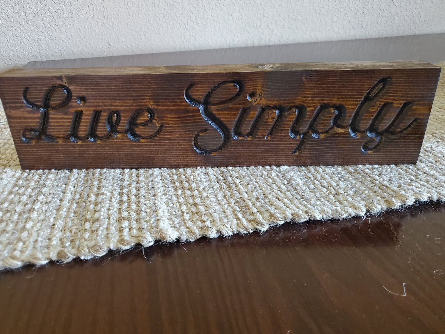 Live Simply carved sign
